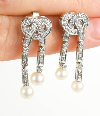 Lot 6 - A 9ct white gold, diamond and pearl drop stud...