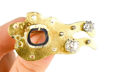 Lot 15 - An 18ct gold and diamond brooch, set with two...