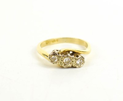 Lot 58 - An 18ct gold and diamond three stone ring, the...