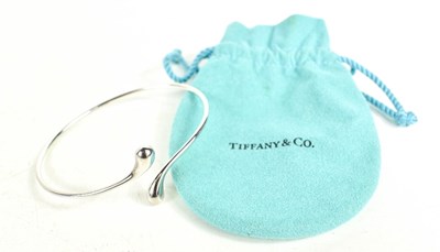 Lot 56 - A Tiffany & Co Elsa Peretti silver bangle,...