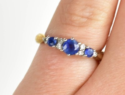 Lot 28 - A 9ct gold, diamond and sapphire ring, size J,...