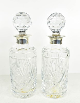 Lot 217 - A pair of silver and cut glass decanters with...