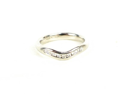 Lot 67 - A platinum and diamond eternity ring, shaped...