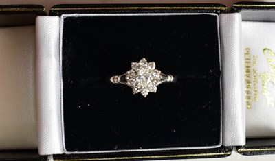 Lot 76 - A platinum and diamond ring, of flowerhead...