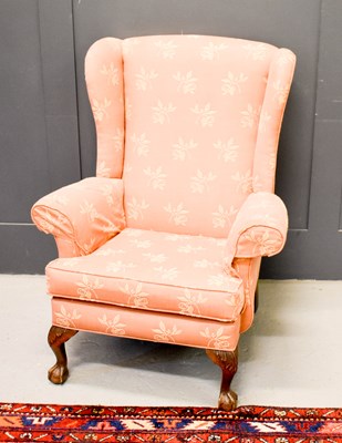 Lot 546 - A Parker Knoll wingback archair with coral...