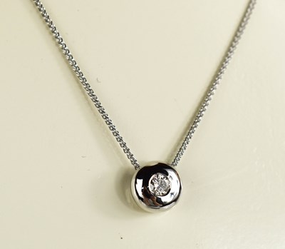 Lot 78 - A 9ct white gold diamond pendant and chain.