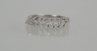 Lot 71a - An 18ct white gold and diamond set nine stone...