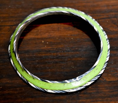 Lot 122 - An early glass bangle, the green glass central...