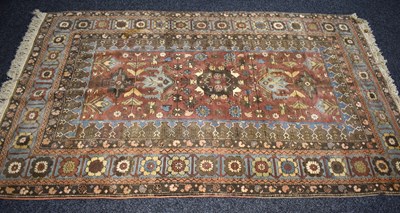 Lot 318 - A Turkish wool rug, red ground with...