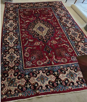 Lot 327 - A large Middle Eastern rug with red ground,...