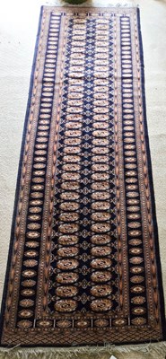 Lot 329 - A Middle Eastern wool runner, dark blue ground...