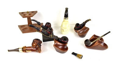 Lot 149 - A group of smoking pipes to include examples...