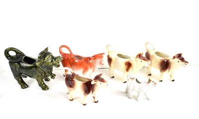 Lot 261 - A group of cow creamer jugs to include...