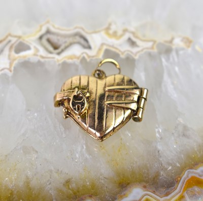 Lot 15 - A 9ct gold heart shaped locket pendant, 5.6g.