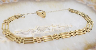 Lot 17 - A 9ct gold gate link bracelet with padlock...