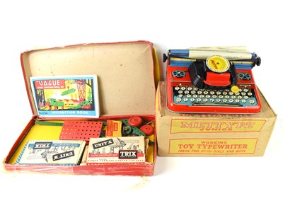 Lot 6 - A Mettype Junior toy typewriter together with...
