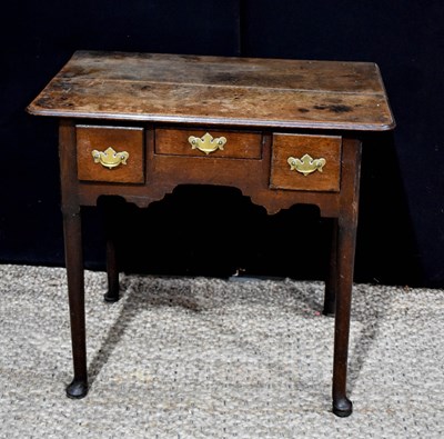 Lot 431 - An 18th century oak lowboy, with three drawers...