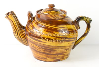 Lot 307 - An Edwardian slipware twin spouted teapot of...