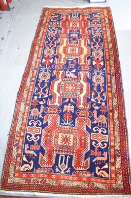 Lot 408 - A red ground Caucasian rug, depicting figures...