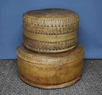 Lot 410 - Two Brazilian leather footstools, worked with...