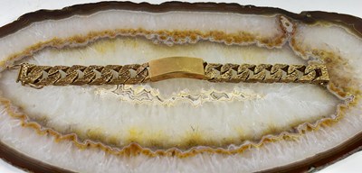 Lot 3 - A 9ct gold identity bracelet with bark effect...