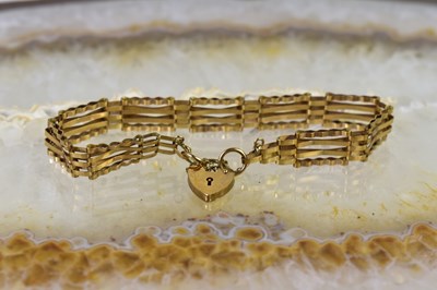 Lot 21 - A 9ct gold gate link bracelet with padlock...