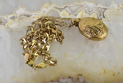 Lot 26 - A 9ct gold photo locket pendant on a 9ct gold...