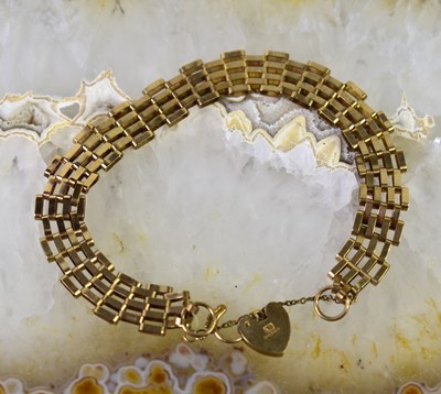 Lot 24 - A 9ct gold gate link bracelet with safety...