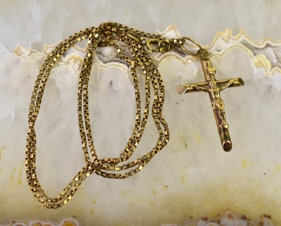 Lot 23 - A 9ct gold crucifix pendant on a 9ct gold...