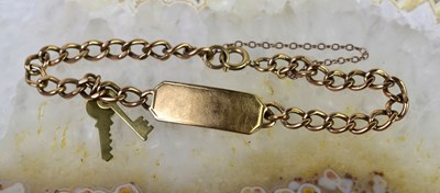 Lot 29 - A 9ct gold identity bracelet with two gold...