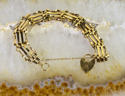Lot 30 - A 9ct gold gate link bracelet with padlock...