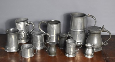 Lot 339 - A group of pewter tankards to include a large...