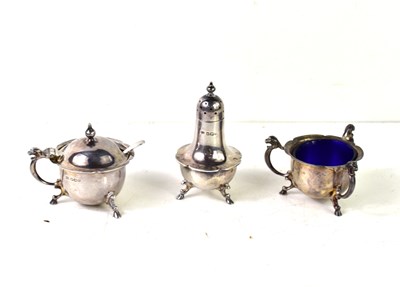 Lot 142 - A silver three piece cruet set, the salt and...