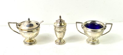 Lot 141 - A silver three piece cruet set, the pepper,...