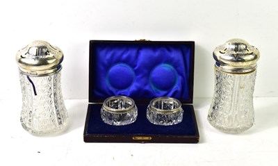 Lot 138 - A pair of cut glass and silver topped sugar...
