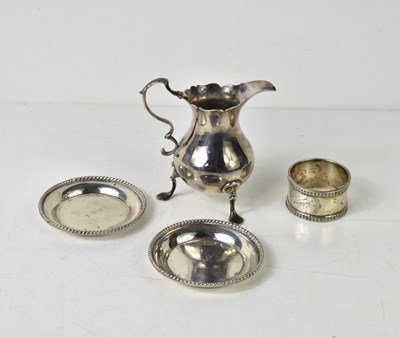 Lot 148 - A group of silver to include a Georgian cream...