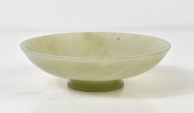 Lot 25 - A small Chinese carved jade dish, 9.5cm diameter.