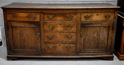 Lot 385 - A large 18th century oak dresser base, with...