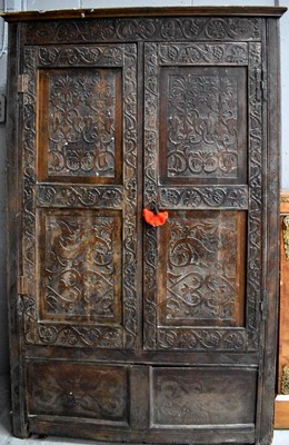 Lot 380 - A 17th century oak cupboard, with two carved...
