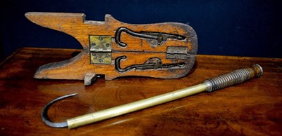 Lot 112 - An antique folding wooden boot pull, together...