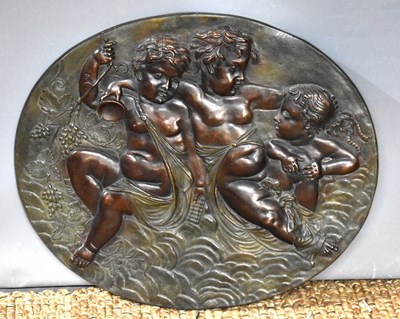 Lot 321 - A bronze oval plaque depicting cherubs in...