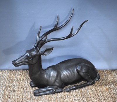 Lot 320 - A large bronzed metal sculpture of recumbent...