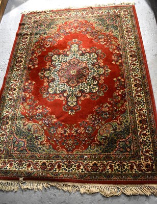 Lot 406 - A vintage Keshan wool rug, red ground, with...