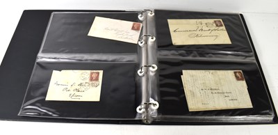Lot 396 - An album of Victorian stamped envelopes with...