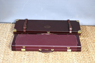 Lot 43 - Two burgundy leather shotgun cases, one made...