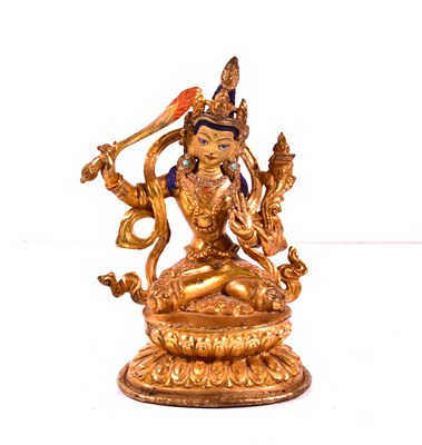 Lot 14 - A 19th century Tibetan gilt bronze jewelled...