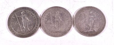 Lot 300 - A group of three British silver trade dollars,...