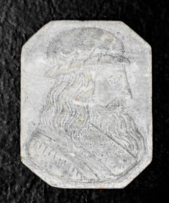 Lot 11 - An early lava stone carved profile portrait...