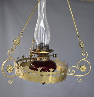 Lot 24 - A late 19th century ruby glass and brass...