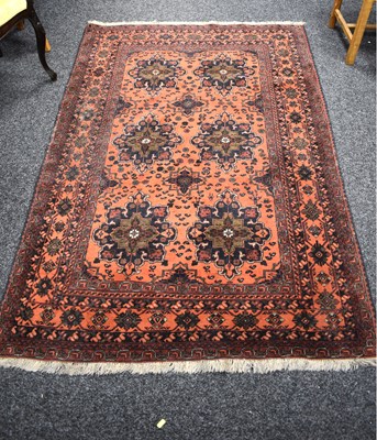 Lot 393 - A Middle Eastern wool red ground rug, six...